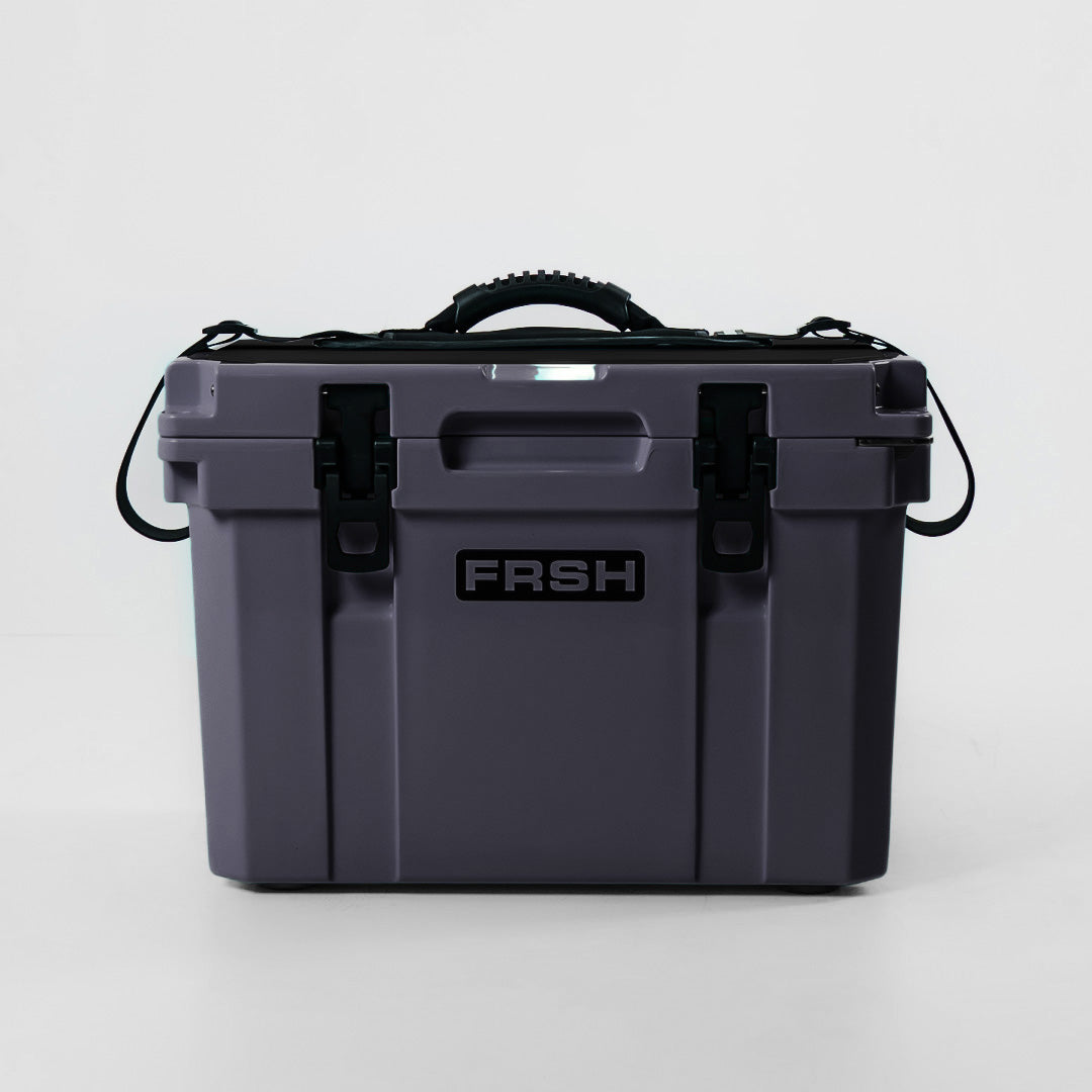 FRSH 17L hard cooler with carbon finish, rugged plastic exterior, and secure lid for outdoor insulation and portability.