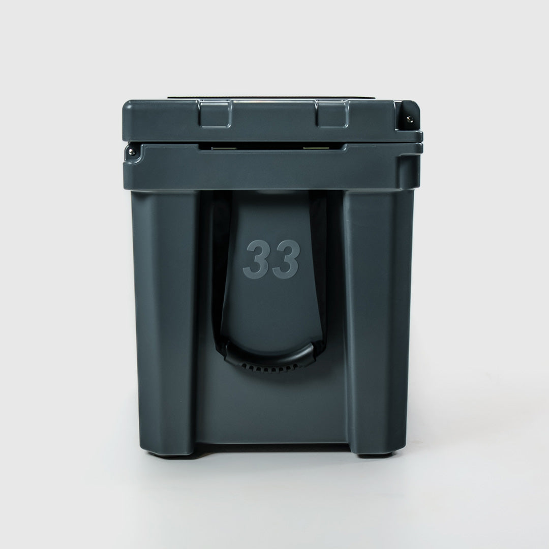 FRSH 33L hard cooler with a sleek carbon finish, featuring sturdy construction and secure latch for outdoor cooling needs.