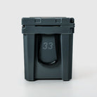 FRSH 33L hard cooler with a sleek carbon finish, featuring sturdy construction and secure latch for outdoor cooling needs.