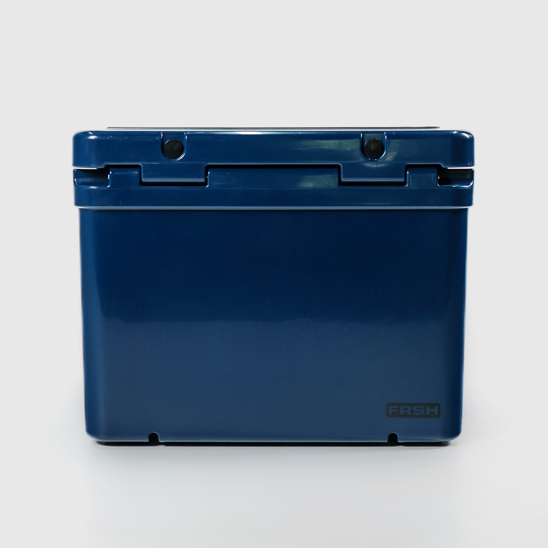 FRSH 55L hard cooler in frozen blue with sturdy handle and secure lid, ideal for keeping food and drinks cold during outdoor activities.
