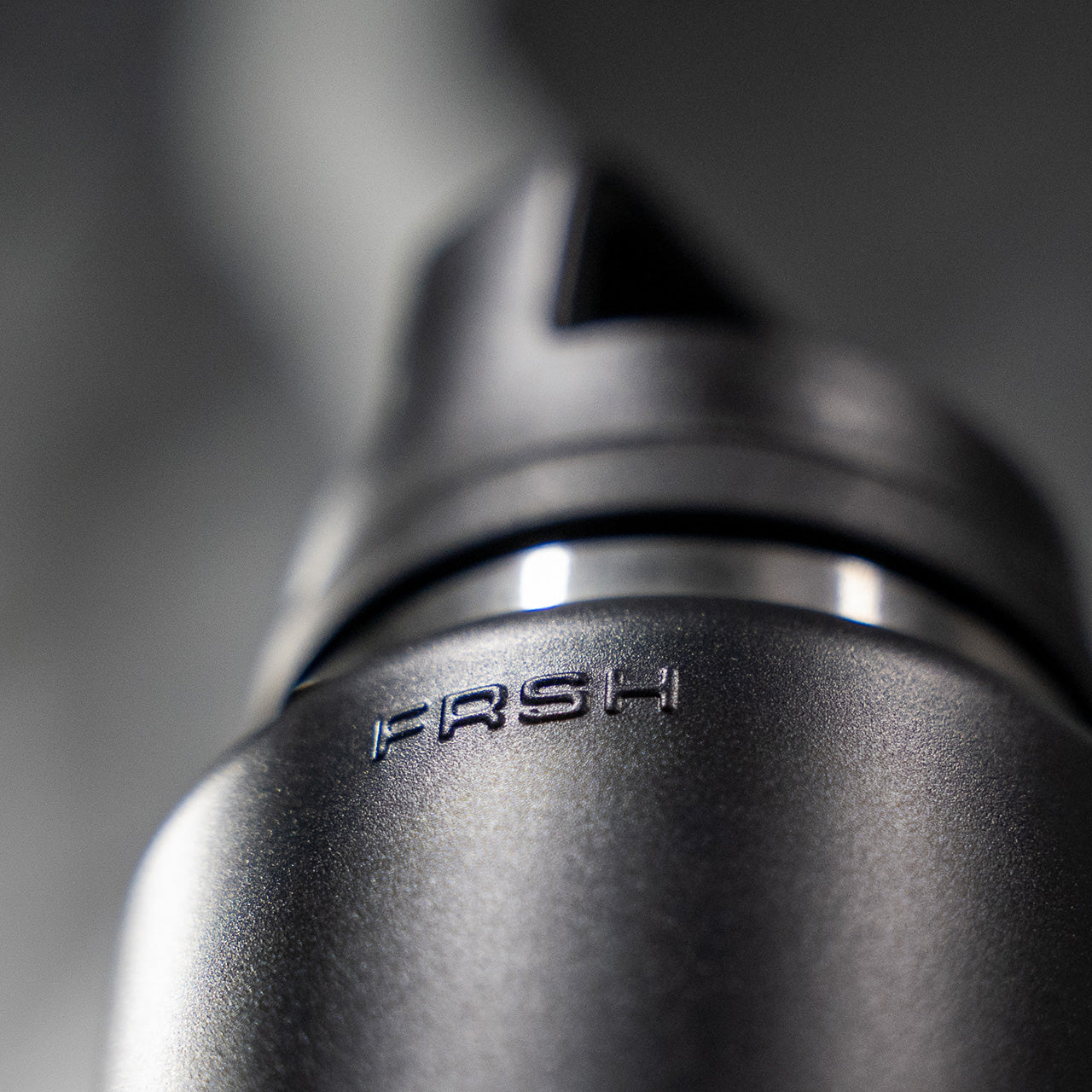FRSH 750ml water bottle with sip lid, transparent plastic design, featuring a black screw-on cap and ergonomic shape.