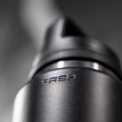 FRSH 750ml water bottle with sip lid, transparent plastic design, featuring a black screw-on cap and ergonomic shape.