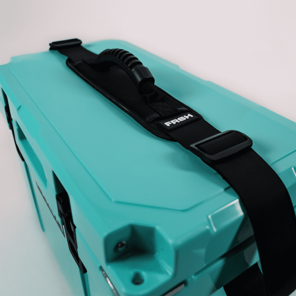 FRSH 17L hard cooler featuring a durable design and an adjustable shoulder strap for easy transport.
